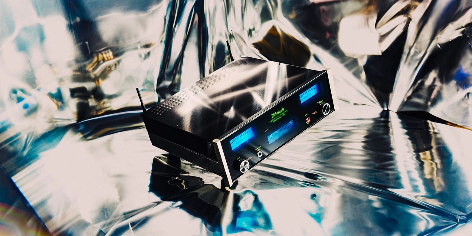McIntosh CS7500 2-Channel Streaming Preamplifier, blue meters lit, on a reflective foil backdrop